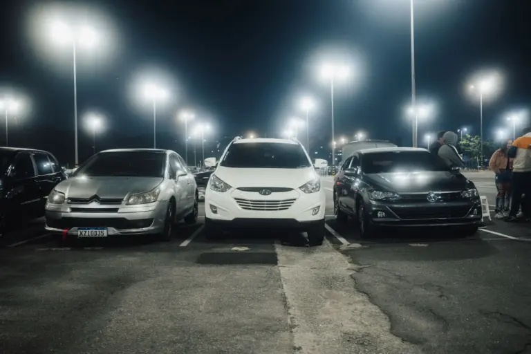 Well lit commercial parking lot with pole lights at night