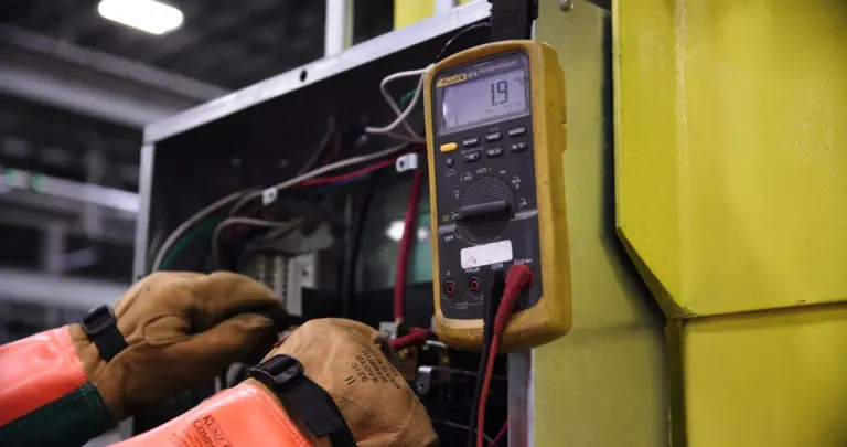 Electrician testing wiring with a multimeter