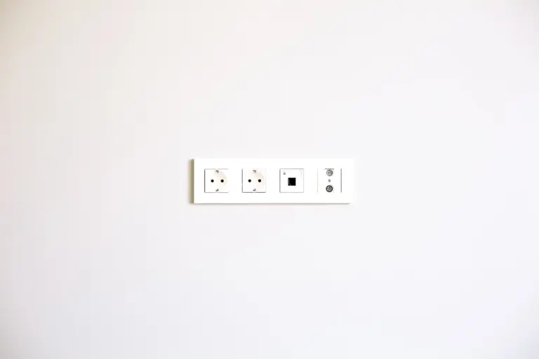 Row of new electrical outlets on a white wall