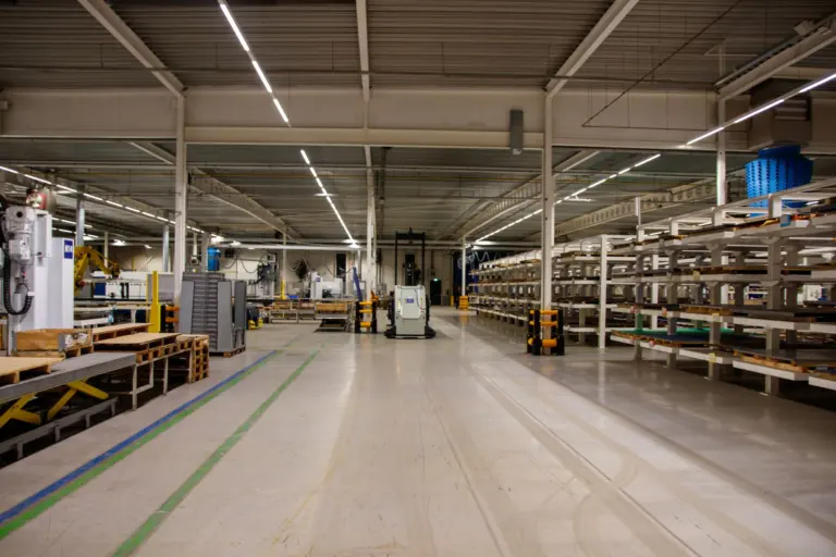 Industrial warehouse interior with machinery and storage shelving