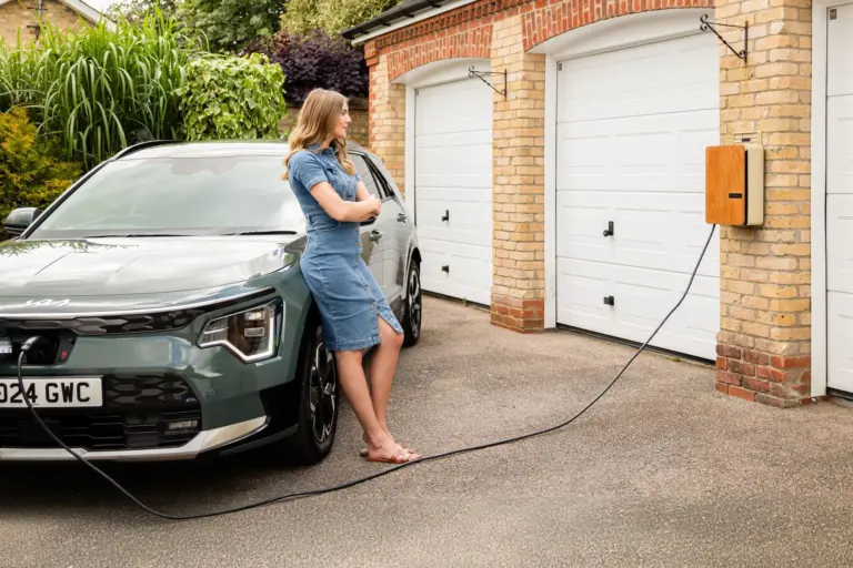 Homeowner using a wall-mounted Level 2 EV charger at home
